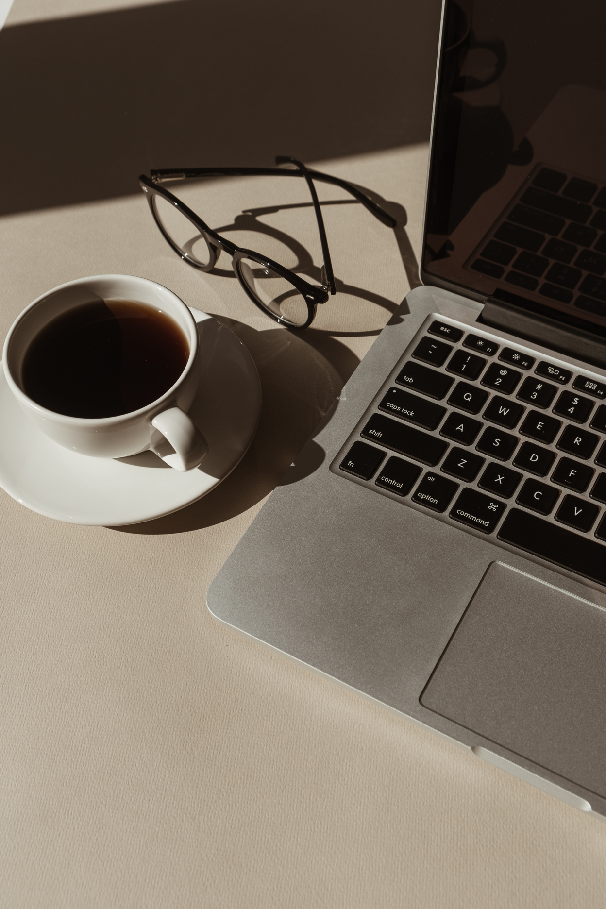 Coffee, Laptop, and Eyeglasses on the Table 
